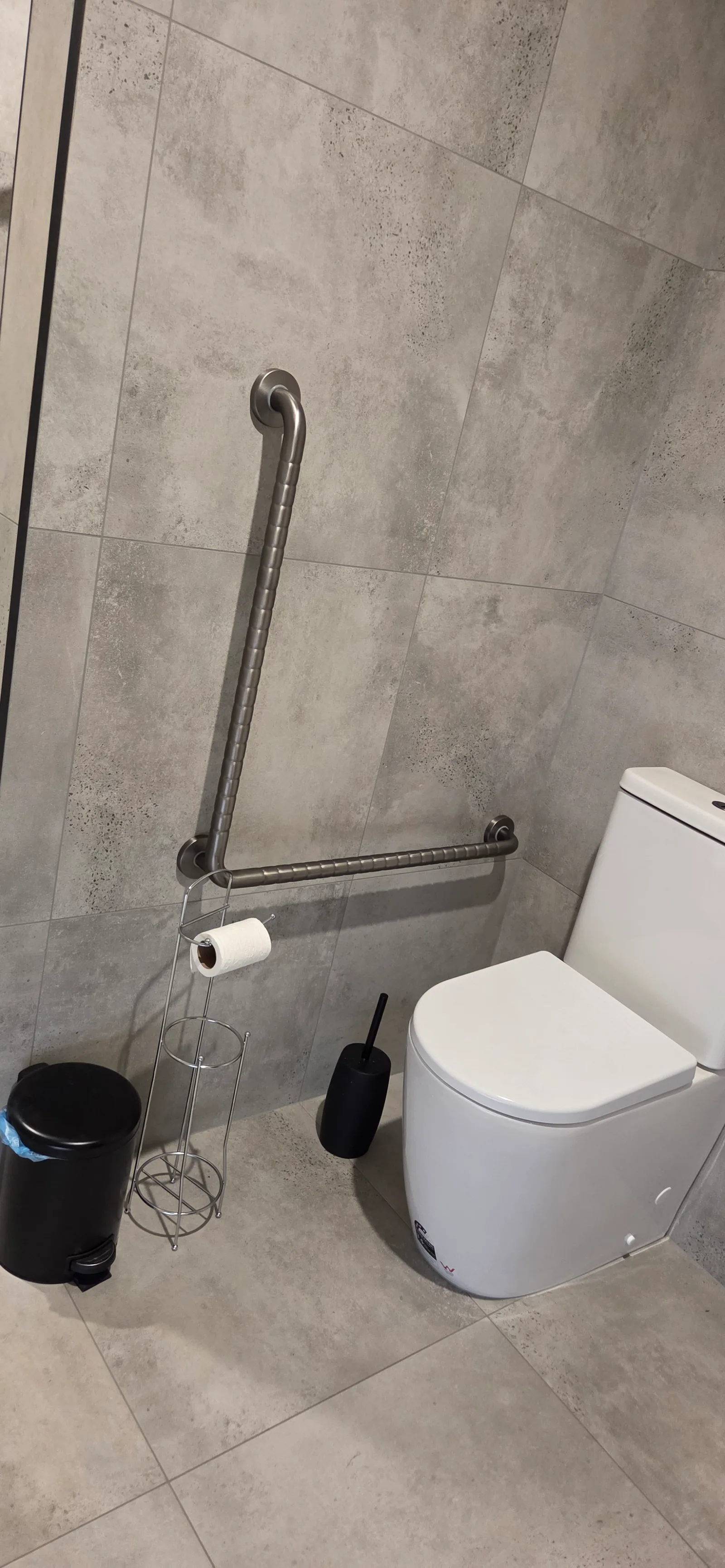 Tiled ensuite with toilet and grab rails