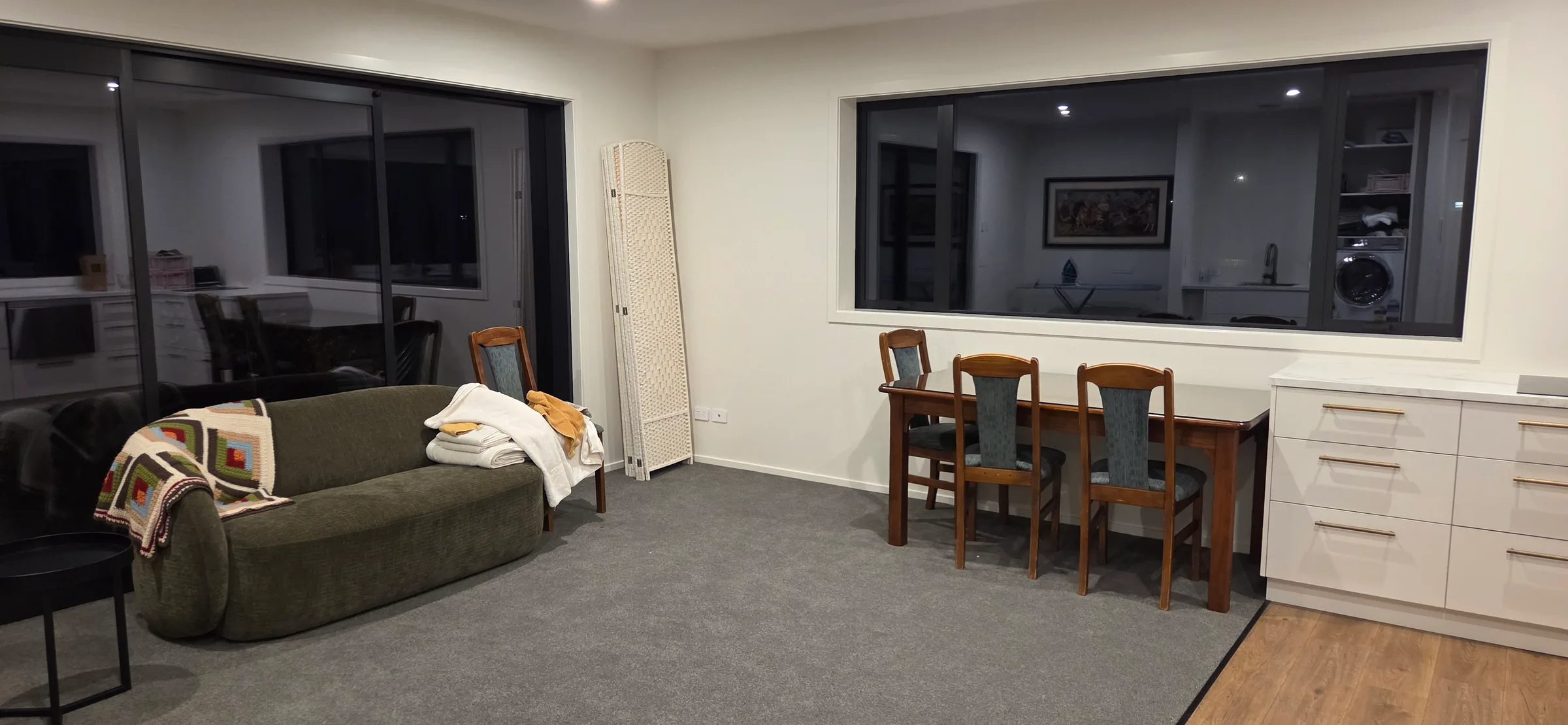 Living area with a sofa, dining table and chairs